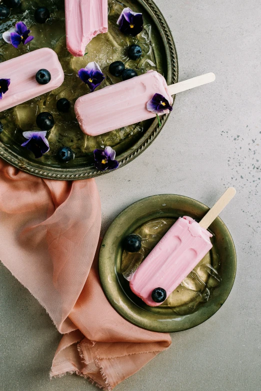 some purple popsicles with blueberries on them