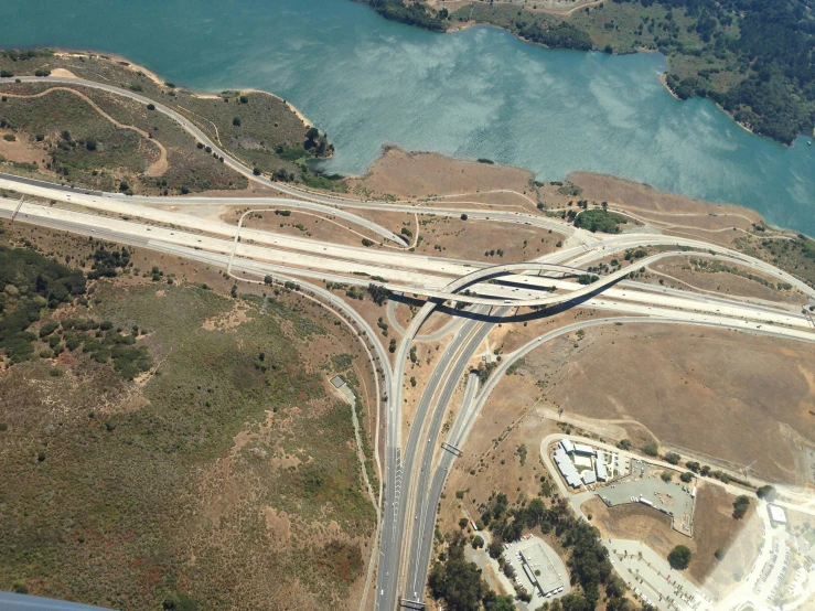 a long highway stretches over an aerial view