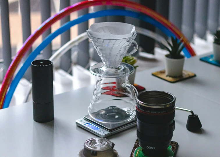 a glass filled with a drink on top of a white table