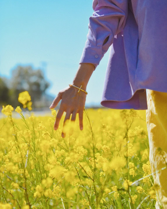 a person with their arm extended in the grass