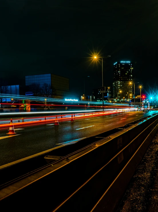 a night scene with a street light and train tracks