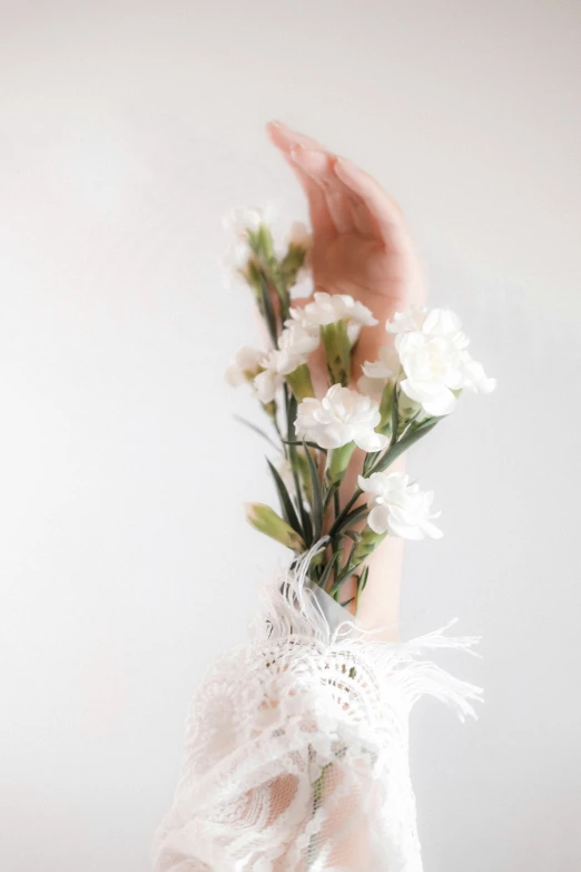 white flowers in the middle of a woman's arm