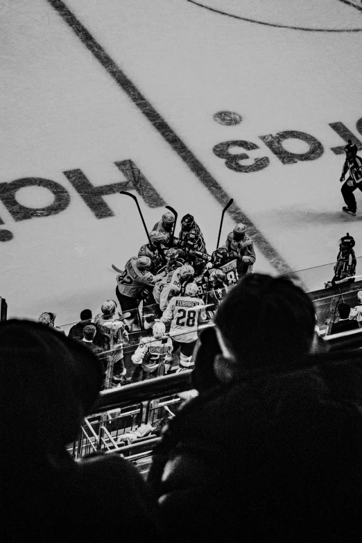 people watching a hockey game on the ice