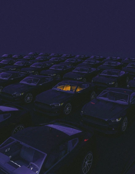 rows of parked cars at night next to a light
