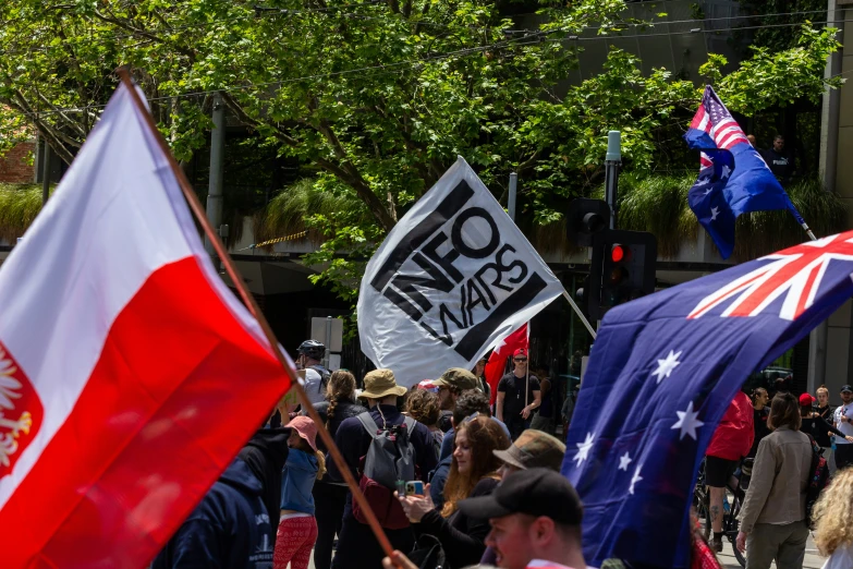 a group of people holding flags standing next to each other