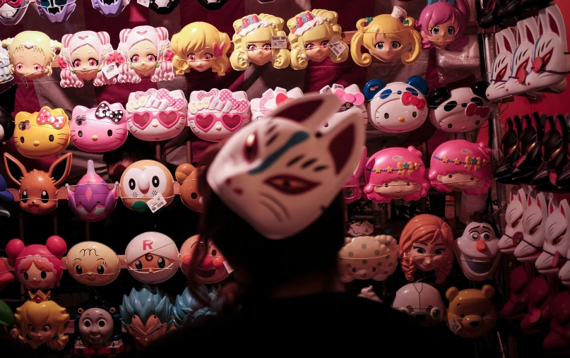 a cat in front of a large group of cat heads