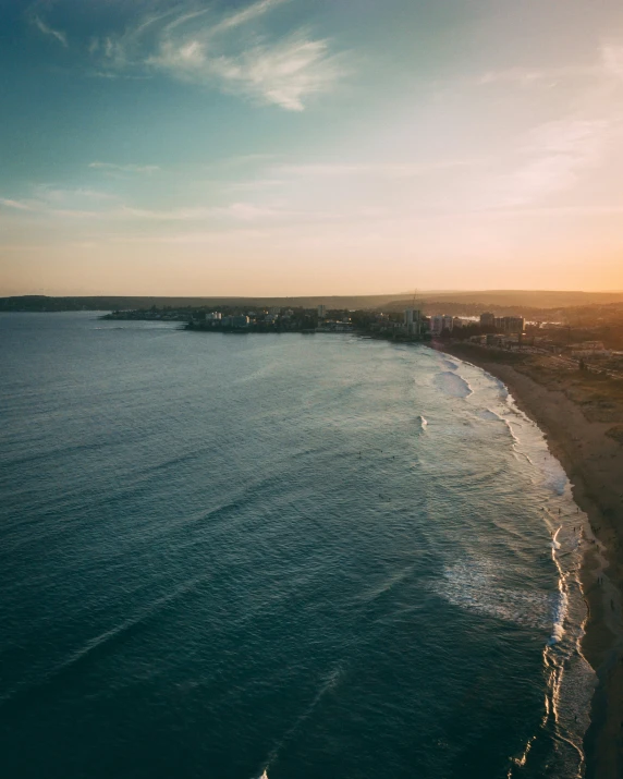 a beach with a body of water at sunset