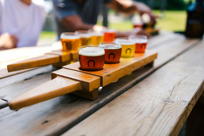 people sitting down at a table with drinks