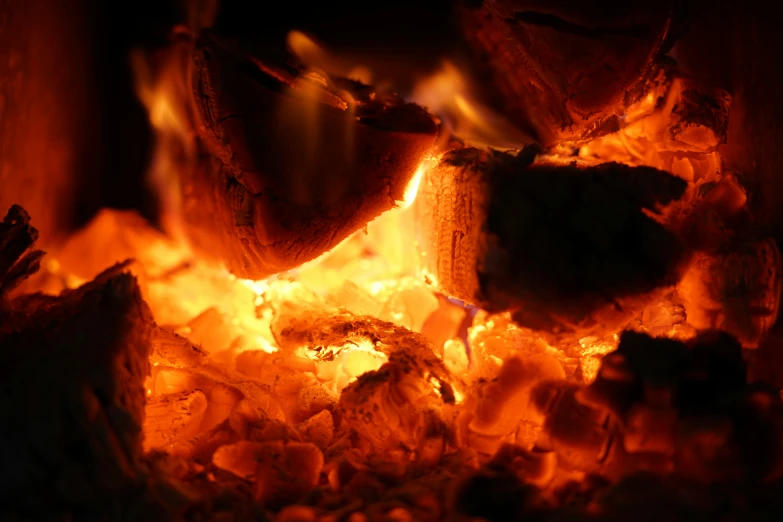  coals in a fire place lit by sunlight