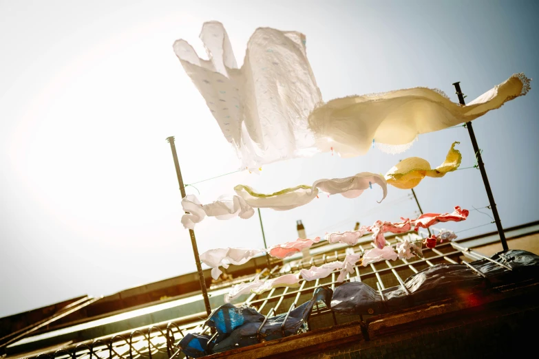 white cloths are hung up with white caps in the air