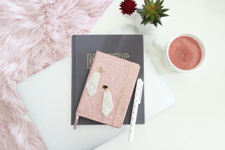 a notebook with glitter cover and pen on it