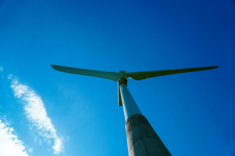 a large wind turbine on top of a blue building