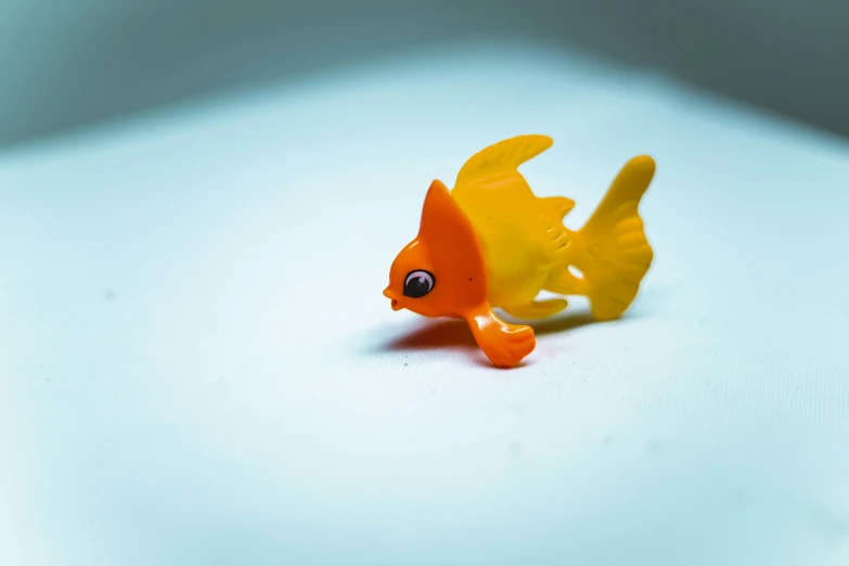 a yellow fish toy with eyes and mouth
