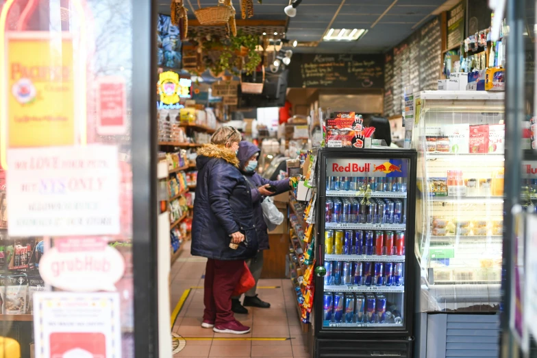 a woman is standing next to the vending machine