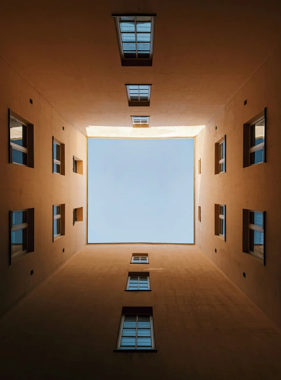 the sky is reflected in the windows of this empty building