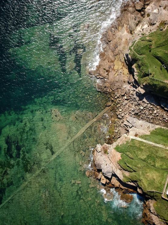 a bird's eye view of the clear blue water by the ocean