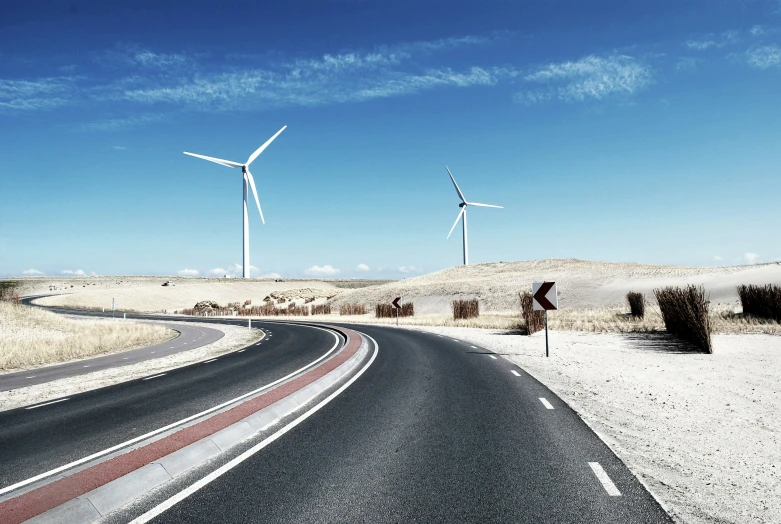 three wind generators on the side of the road