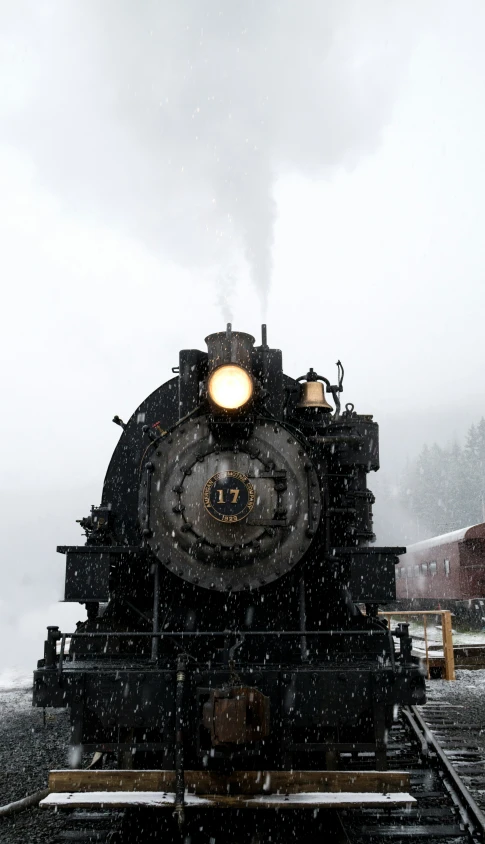 an old train on a snowy day with fog