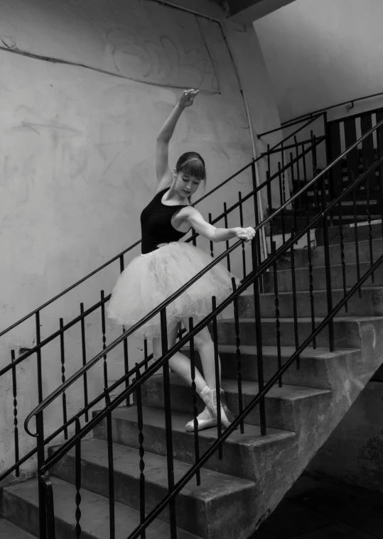 black and white pograph of a girl in tutu on the steps