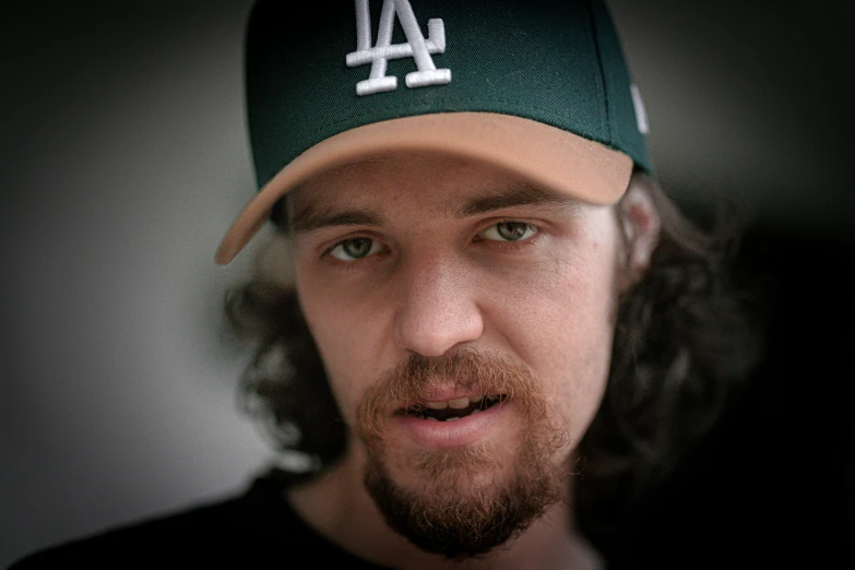 a man wearing a los angeles baseball hat