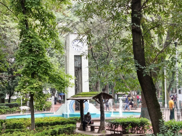 a park with several people sitting on benches