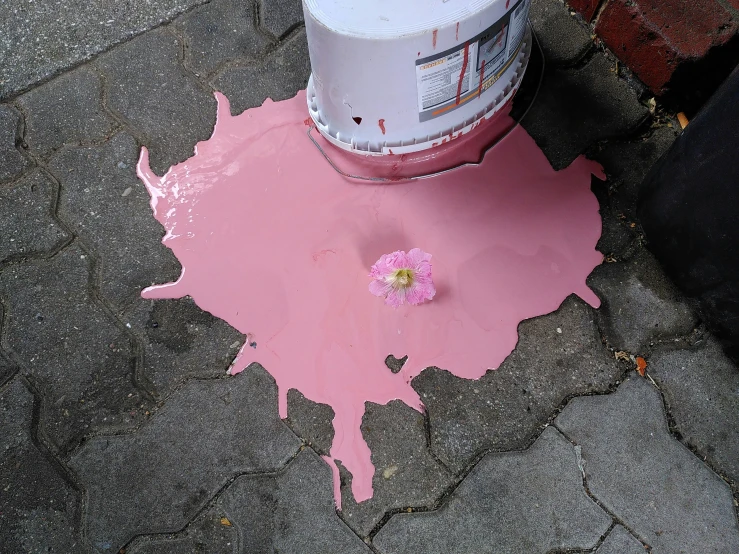 the pink paint is dripping down on the ground