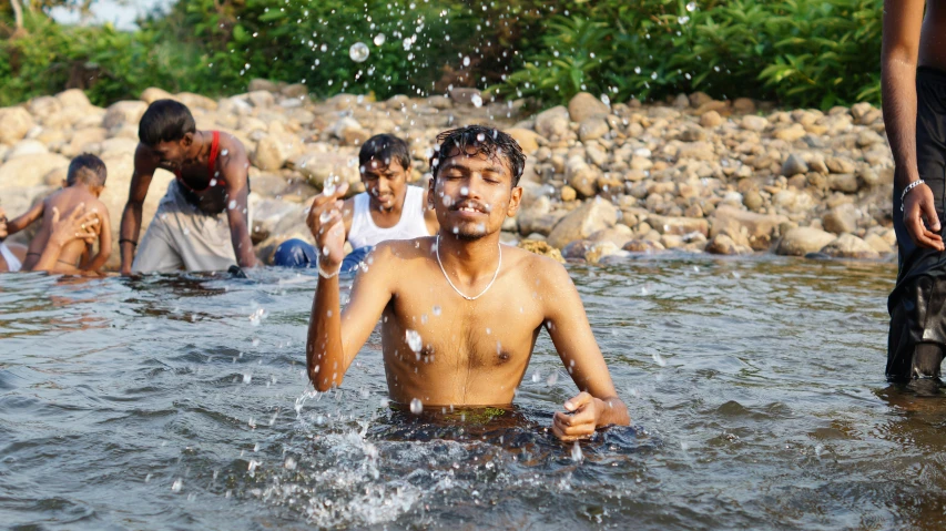 a group of boys playing in the water