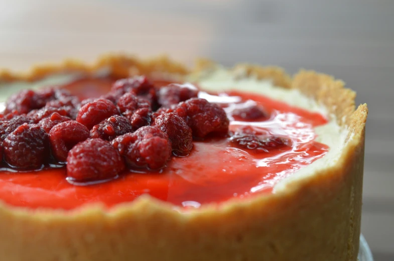 raspberry cheesecake with pink topping on plate