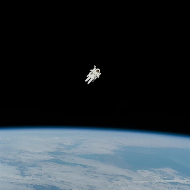 an astronaut floating in the space near earth