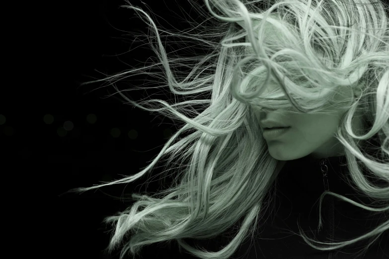 a woman with her hair blowing in the wind