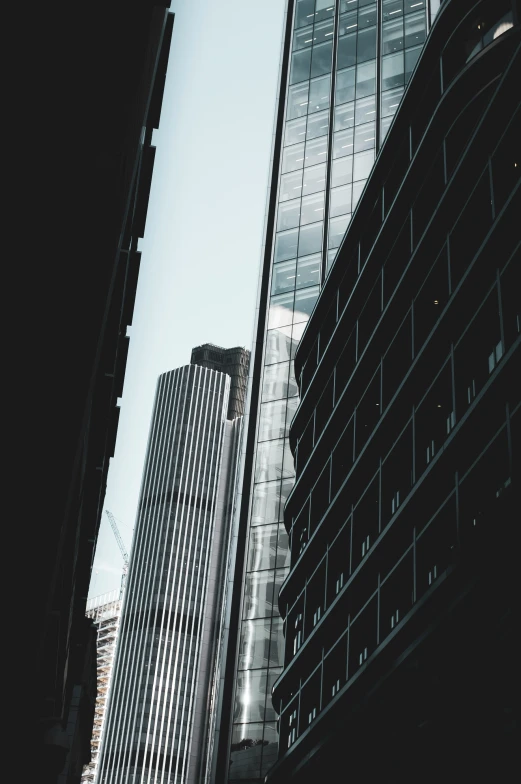 two tall buildings with windows next to each other