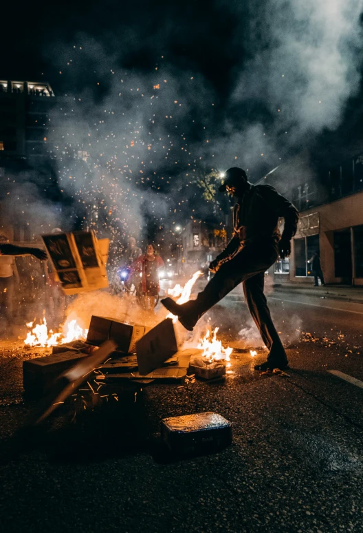 a person jumping over a fire on the street