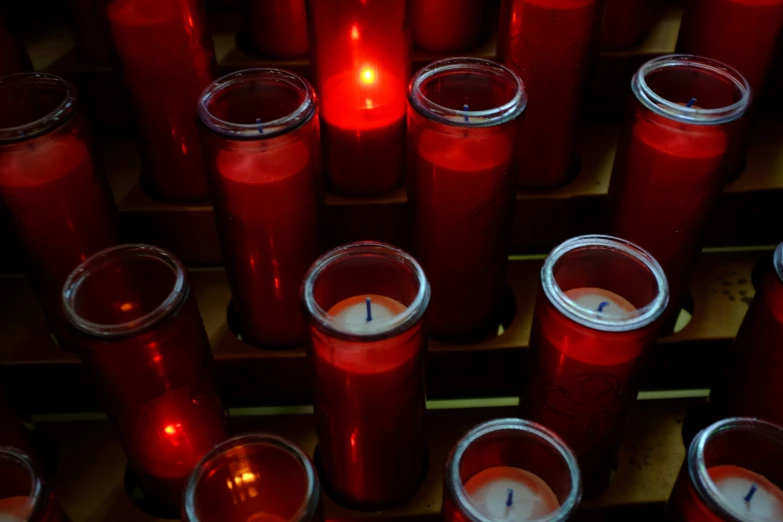 a group of red candles sitting next to each other