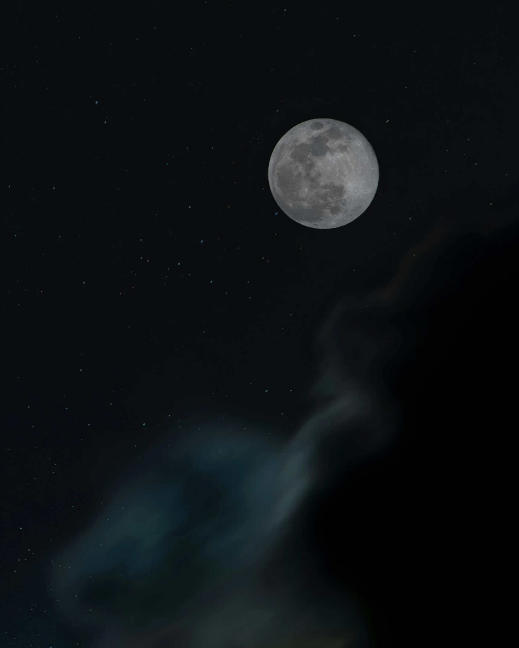 the moon in a cloudy night sky