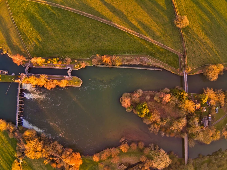 aerial view of an autumn scene with water and hills in the background