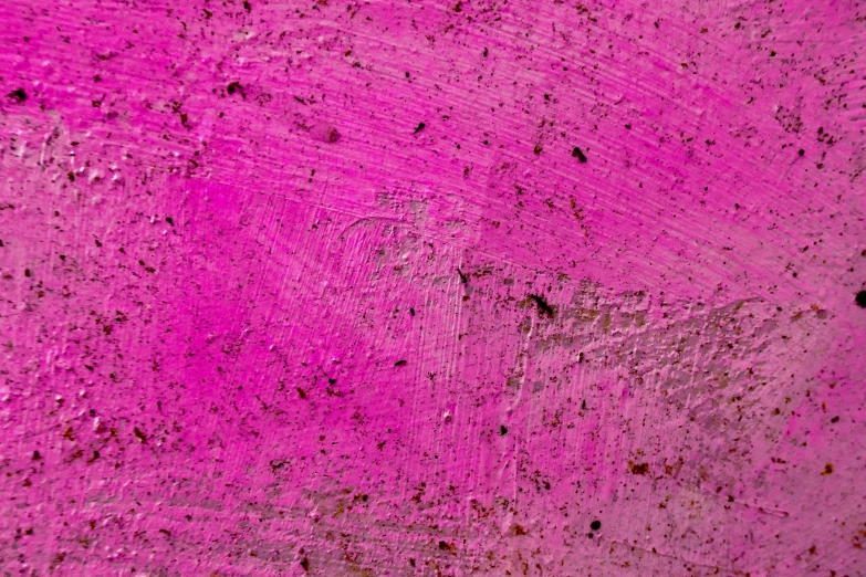 a grungy surface painted in  pink colors