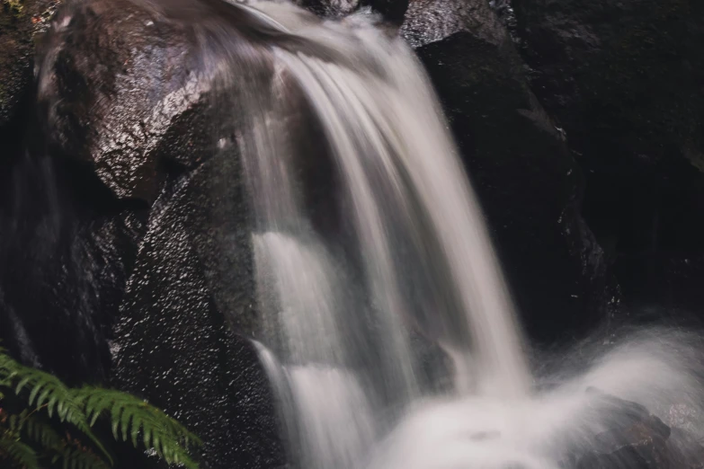 the small waterfall is flowing among the rocks