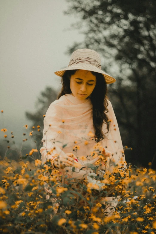 a woman is standing among the yellow flowers