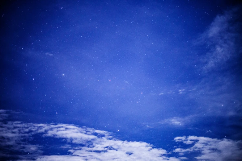 a po taken in the night sky looking up at the clouds