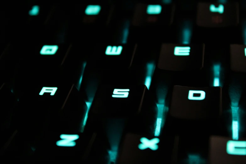 close up view of a keyboard illuminated with green light