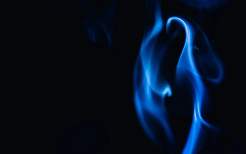 a blue fire is rising up into the air