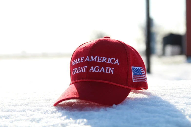 the red america great again hat on snow covered ground