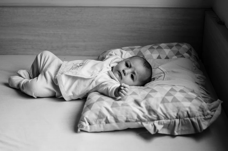 a baby laying in a crib and trying to sleep