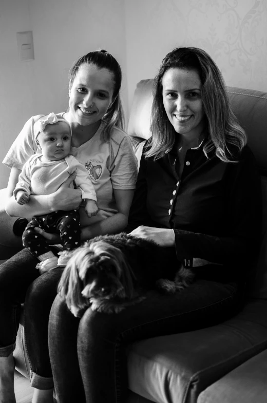 black and white po of mom, daughter, and dog