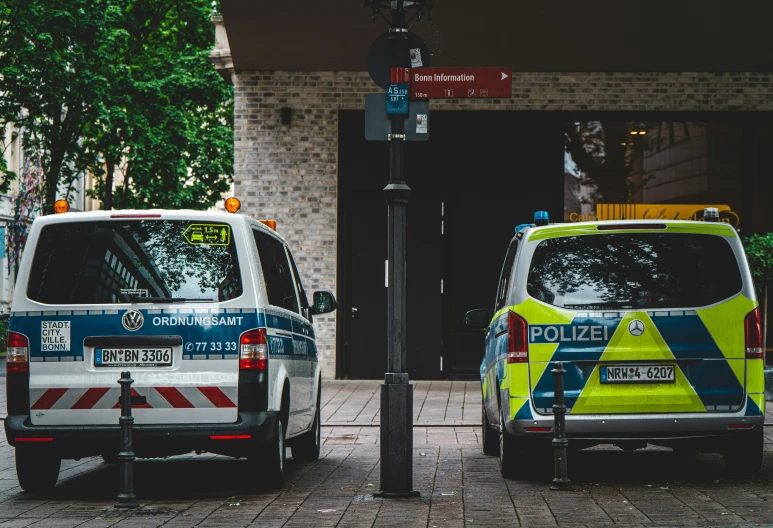 a couple of parked vans that are on the side of a road