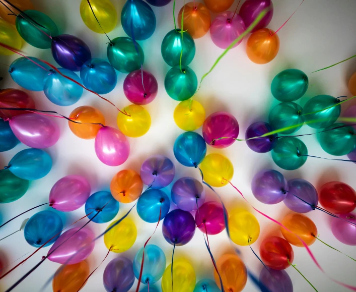 a bunch of balloons are grouped in an orderly manner