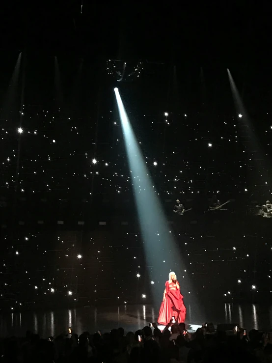 a large stage with lights coming through the curtains