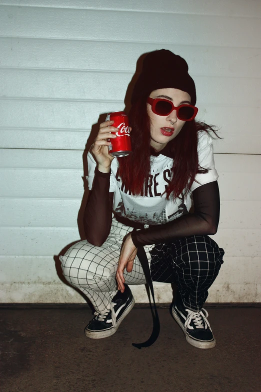 a woman sitting on the floor drinking from a coffee cup