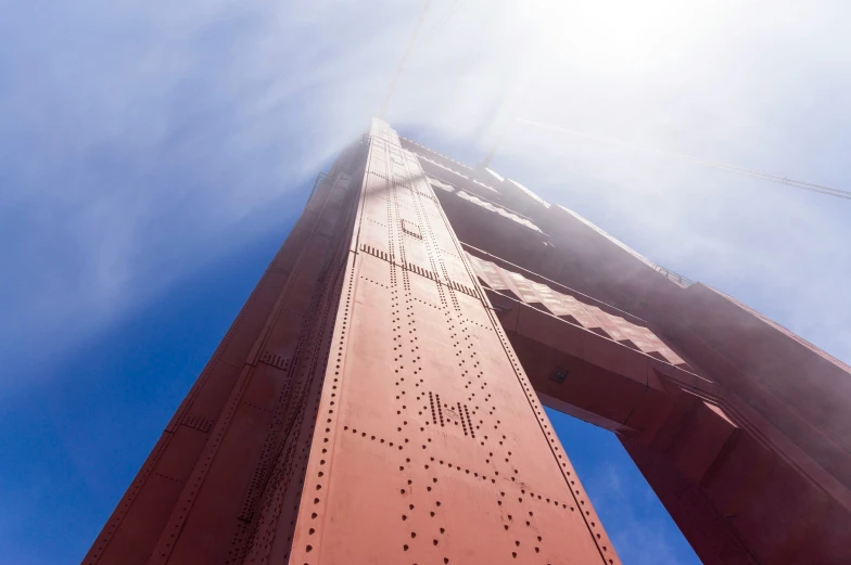 a tall, narrow tower on top of a metal bridge