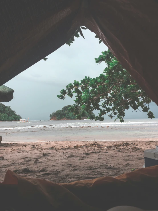 a view of a beach through some tents